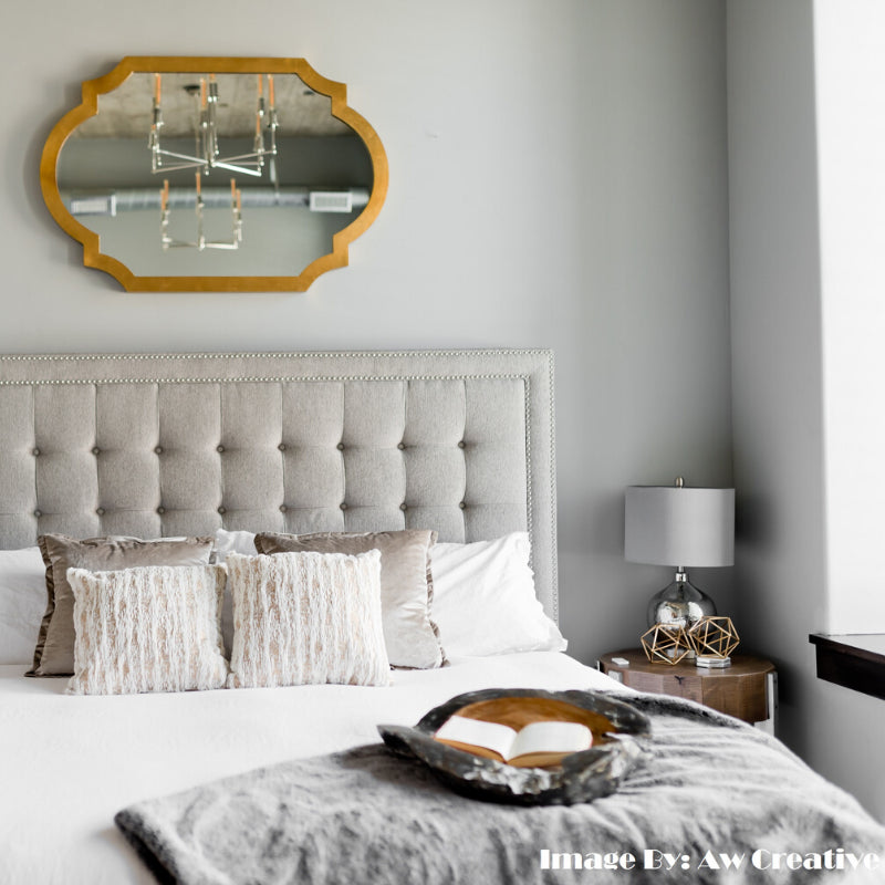 Minimalist bedroom with neutral tones and metallic accents reflecting balance and tranquility