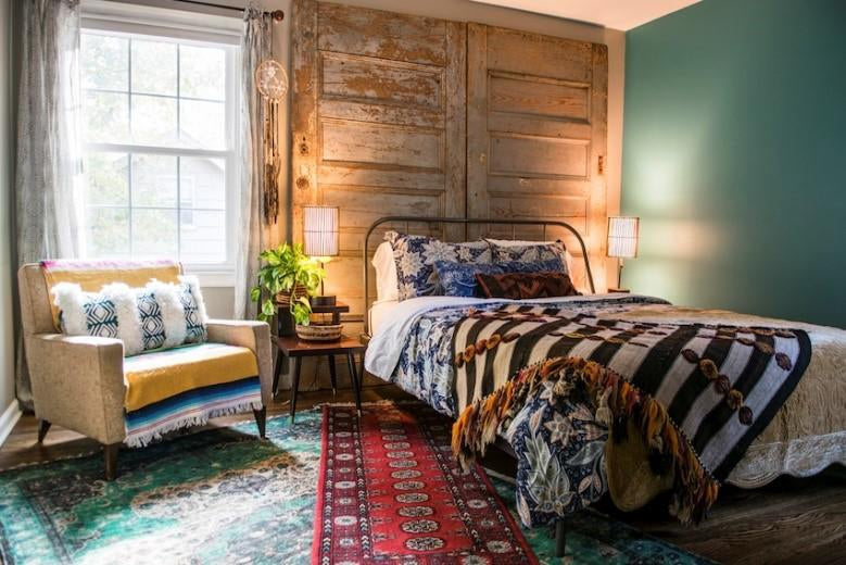 6 Essentials of a Free-spirited Farmhemian Home-Brush Point Studio (Cozy bedroom with rustic wood headboard, patterned textiles, and warm lighting from bedside lamps.)