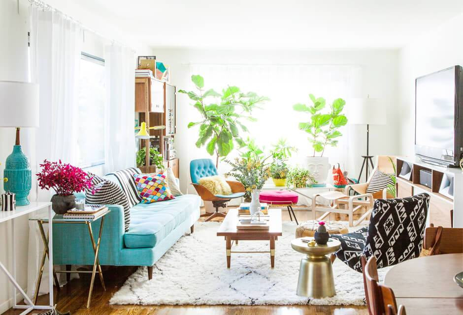 Create a Boho Chic Home with 7 Essential Elements-Brush Point StudioAlt text: “Bright Bohemian living room with colorful patterned cushions, mid-century furniture, lush indoor plants, and layered textures creating a vibrant, free-spirited interior.”