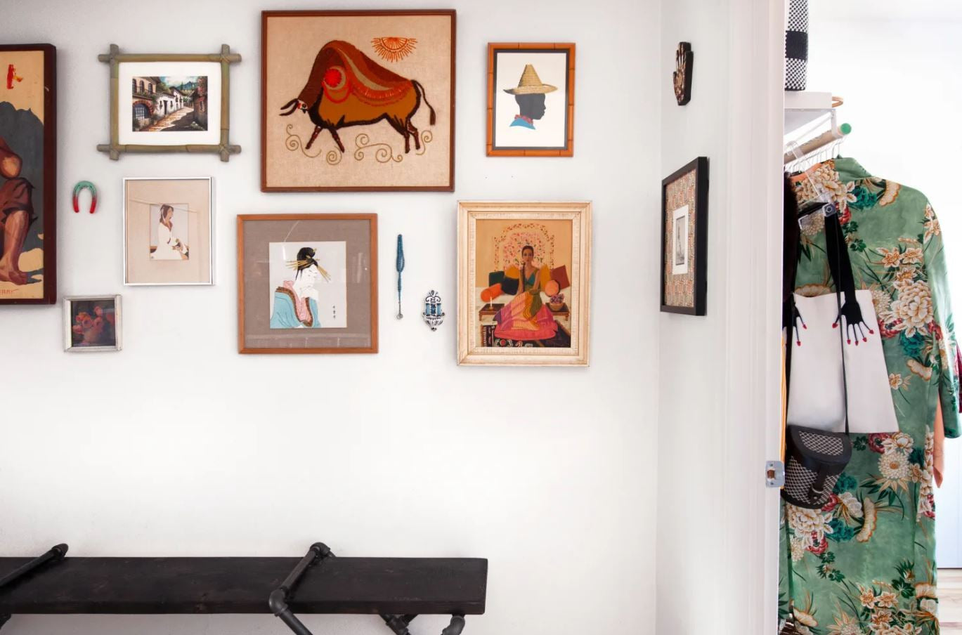 How to Successfully Mix Artwork from Different Artistic Styles-Brush Point Studio (Gallery wall with framed artwork and patterned clothing nearby.)