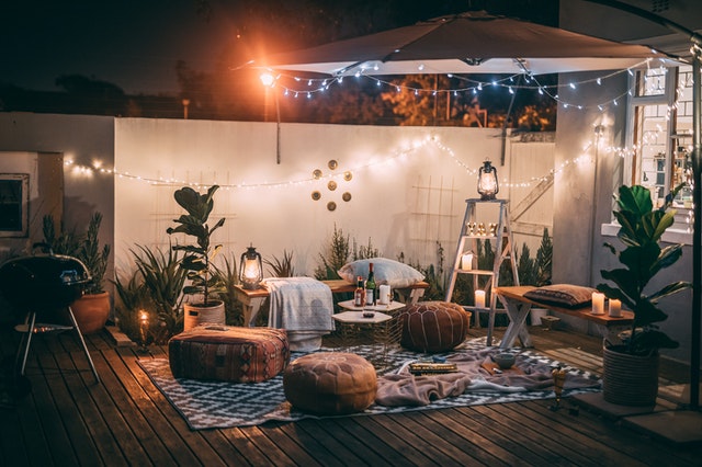 Cozy outdoor patio with string lights and tropical plants