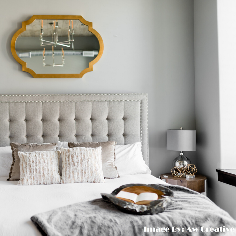 Minimalist bedroom with neutral tones and metallic accents reflecting balance and tranquility