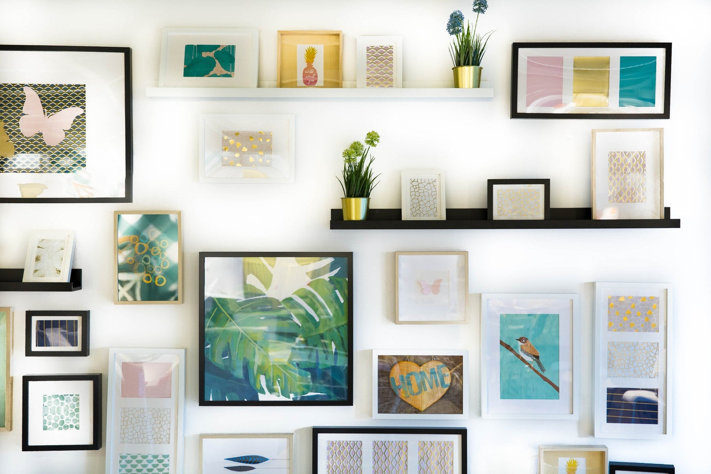 wall art gallery with framed prints and plants for modern home decor